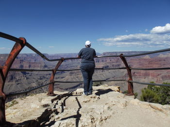 Rear view of woman standing on cliff at grand canyon national park
