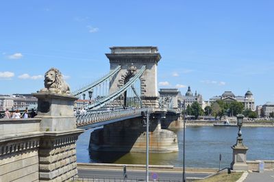 Bridge over river with city in background