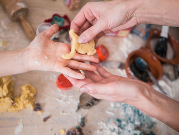 Cropped hands of people preparing food in kitchen