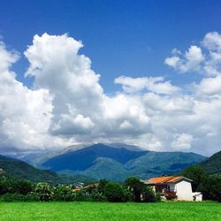 Scenic view of mountains against cloudy sky