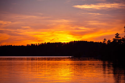 Scenic view of lake against romantic sky at sunset