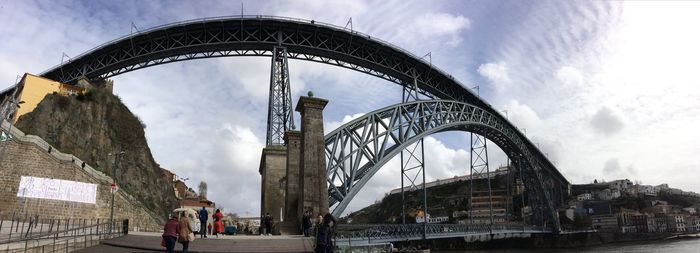 Low angle view of bridge against cloudy sky