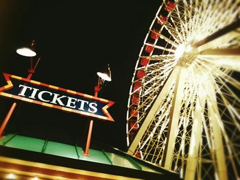 Low angle view of illuminated ferris wheel at night