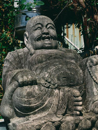 Close-up of buddha statue against building