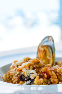 Close-up of risotto served in bowl against sky