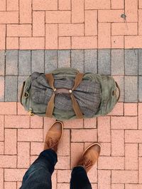 Low section of man standing on footpath