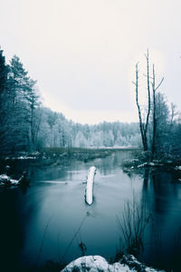 Scenic view of lake against sky during winter