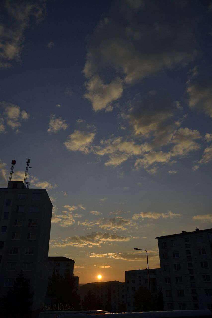 building exterior, architecture, built structure, sunset, sky, silhouette, cloud - sky, city, low angle view, residential building, residential structure, building, house, orange color, cloud, sun, sunlight, outdoors, cloudy, no people