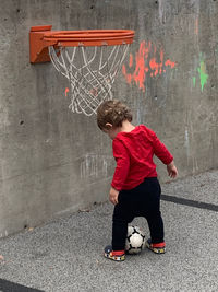 Boy playing with basketball hoop