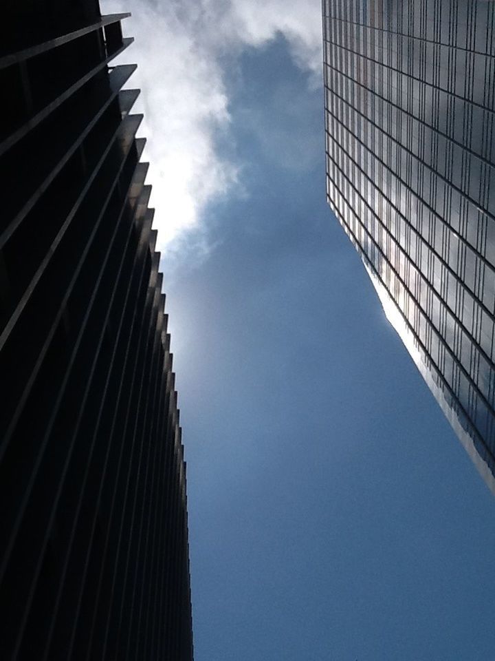 architecture, low angle view, built structure, building exterior, modern, skyscraper, tall - high, office building, tower, city, sky, building, directly below, cloud - sky, tall, glass - material, reflection, day, outdoors, no people