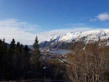 Scenic view of land and mountains against sky