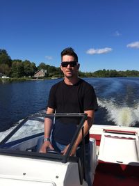 Young man in sunglasses against sky