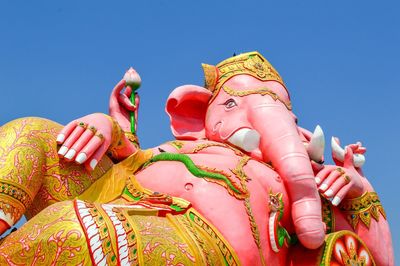 Low angle view of lord ganesha against sky