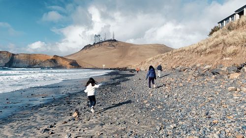 Rear view of people walking on mountain