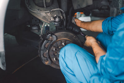 Midsection of man working in garage