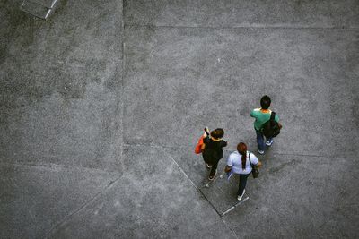 High angle view of friends standing on street