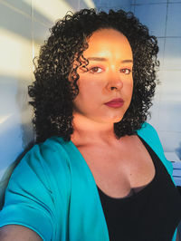 Portrait of beautiful woman standing at home