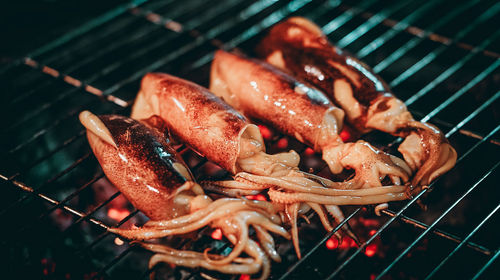 High angle view of meat on barbecue grill