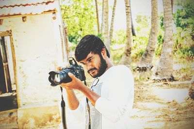 Young man photographing