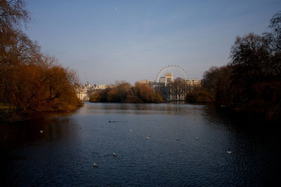 Scenic view of river by trees against sky