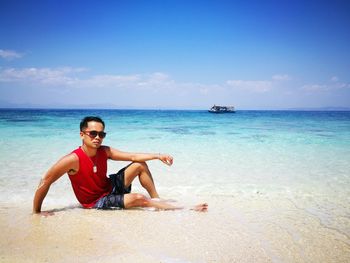 Portrait of man on beach against sky