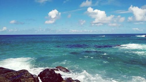 Scenic view of sea against cloudy sky