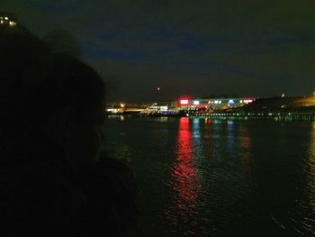 Illuminated reflection of sky in water at night