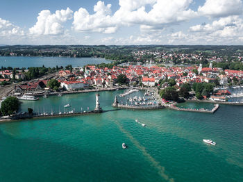 High angle view of buildings by sea against sky