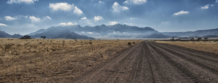 Panoramic view of agricultural field against sky