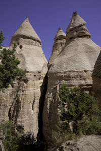 Low angle view of rock formation against sky