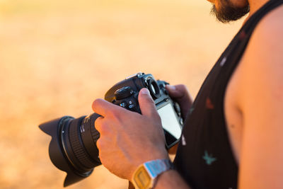 Close-up of man photographing camera