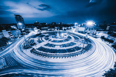 High angle view of illuminated city street against sky at night