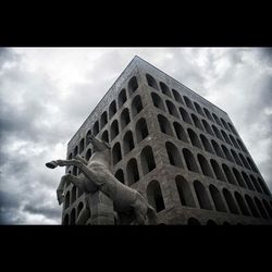 Low angle view of building against cloudy sky