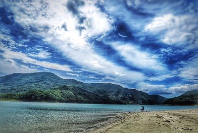 Scenic view of mountains against cloudy sky