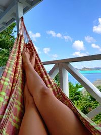 Low section of woman relaxing on hammock