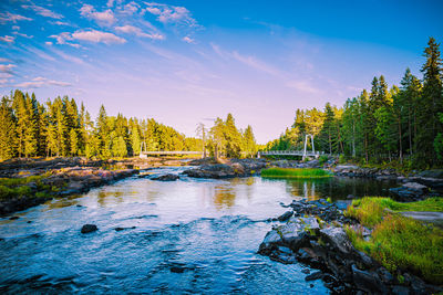 Scenic view of waterfall against sky