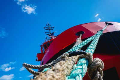 Low angle view of people in boat against sky