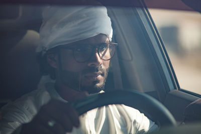 Portrait of man seen through car window