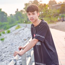 Portrait of teenage boy standing outdoors