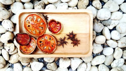 High angle view of fruits on pebbles