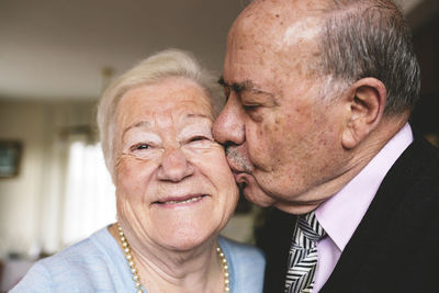 Senior man kissing his happy wife