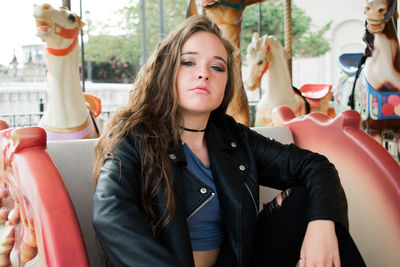 Portrait of young woman sitting outdoors