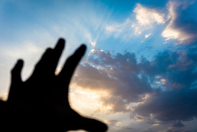 Silhouette person against sky during sunset
