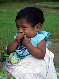 Close-up of boy sitting outdoors