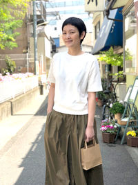 Portrait of smiling woman standing in city