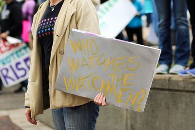 Midsection of woman holding umbrella