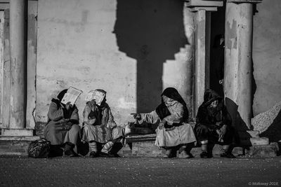 People sitting outside building