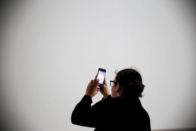 Rear view of woman photographing