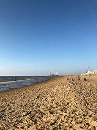 Scenic view of beach against clear blue sky