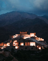 High angle view of buildings in town against sky at night